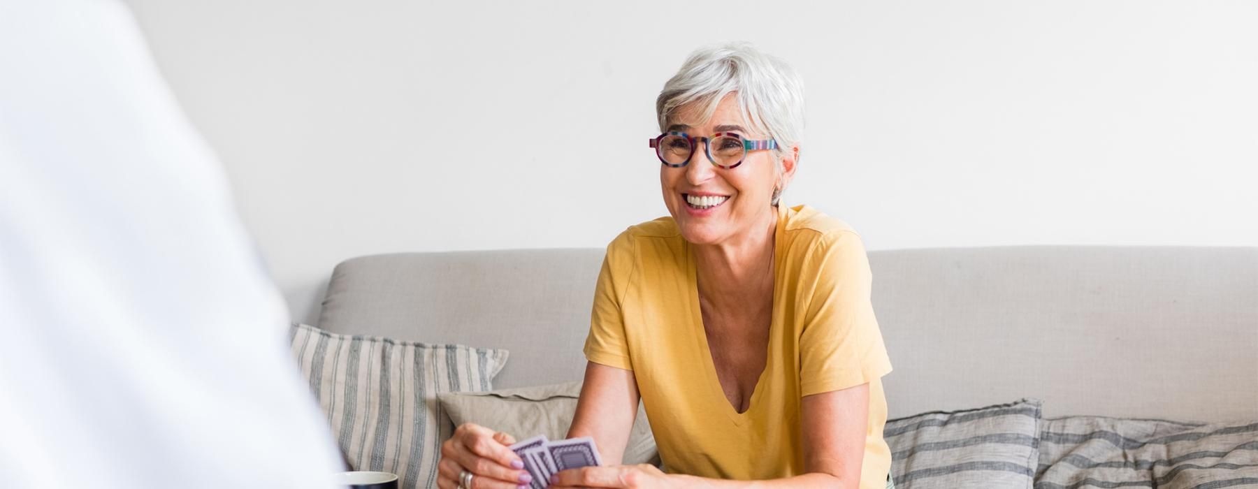a person sitting on a couch playing cards