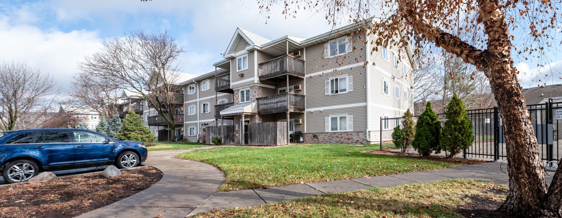 a red fire hydrant in front of a large house